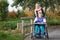 Disabled girl in a wheelchair relaxing outside