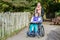 Disabled girl in a wheelchair relaxing outside