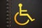 Disabled icon yellow in black copybook. Disabled people equal rights diversity program concept