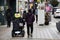 Disabled korean travelers people sit on auto machine wheelchair on footpath for travel visit at Nampo dong Shopping Center or