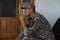 Disabled male veteran sitting and praying. He is wearing military uniform