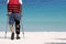 Disabled man with crutches while travel on the beach