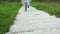 Disabled man with crutches walking on footway