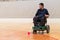 Disabled man on an electric wheelchair playing sports, powerchair hockey. IWAS - International wheelchair and amputee