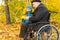 Disabled man and his grandson enjoying autumn