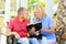 Disabled man with his wife fiilng happy while reading holy bible