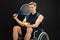 Disabled man holding racket and ball