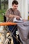 Disabled man ironing