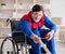 Disabled man repairing chair in workshop