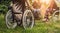 Disabled man resting in a campsite with friends. Wheelchair in the forest