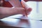 Disabled man with two amputated stump hands signs documents makes paper work.