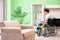 The disabled man on wheelchair cleaning house