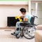 Disabled man on wheelchair cleaning house