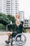 Disabled man in wheelchair throwing ball to basket