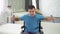 Disabled man in a wheelchair, training with dumbbells at home slow mo