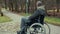 Disabled man in wheelchair waiting for assistance on path in the park