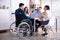 Disabled Manager Sitting With His Colleagues