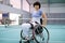 Disabled mature woman on wheelchair on tennis court