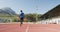 Disabled mixed race man with prosthetic legs running on race track