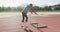 Disabled mixed race man with prosthetic legs stretching with a hurdle