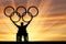 Disabled Paralympic keep olympic rings sunset