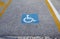 Disabled parking permit sign painted on the street