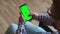 Disabled Person man clicks on the chromakey phone screen, back view. Disabled Person special needs uses phone with