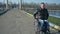 Disabled person rides to embankment along sea on wheel chair, portrait