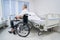 Disabled person seated in wheeled chair in rehabilitation facility