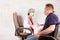 A disabled person in a wheelchair at an appointment with a rehabilitation doctor