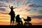 Disabled person in wheelchair and pram and family sunset