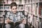 Disabled schoolboy reading book in library