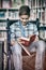 Disabled schoolboy reading book in library