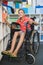 Disabled schoolboy selecting a book from bookshelf in library