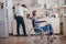 Disabled senior woman sitting in wheelchair in kitchen