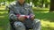 Disabled soldier holding american flag in hands sitting in wheelchair, patriot