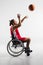 Disabled sportsman throwing basketball