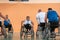 Disabled War veterans mixed race and age basketball teams in wheelchairs playing a training match in a sports gym hall