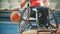 Disabled wheelchair, basketball player practice playing with tha ball in the sport hall