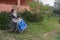 Disabled woman alone in a wheelchair with a protective mask looking to the right in a garden but in quarantine