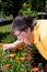 Disabled woman cuts flowers in the garden