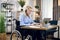 Disabled woman in headset having video call on laptop