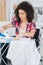 Disabled woman ironing shirt