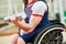 Disabled woman in wheelchair lifting weight in gym. handicapped people activity