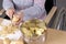 Disabled woman in wheelchair peeling potatoes