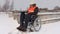 Disabled worker on wheelchair checking building materials