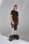 Disabled young man on hoverboard with leg prosthesis in the studio. Shadow light.