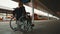 Disabled young woman waiting for a train in the wheelchair