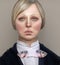 Disappointed Blond woman, in teacher`s clothes on grey background