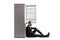 Disappointed businessman sitting on the floor and leaning on an empty fridge